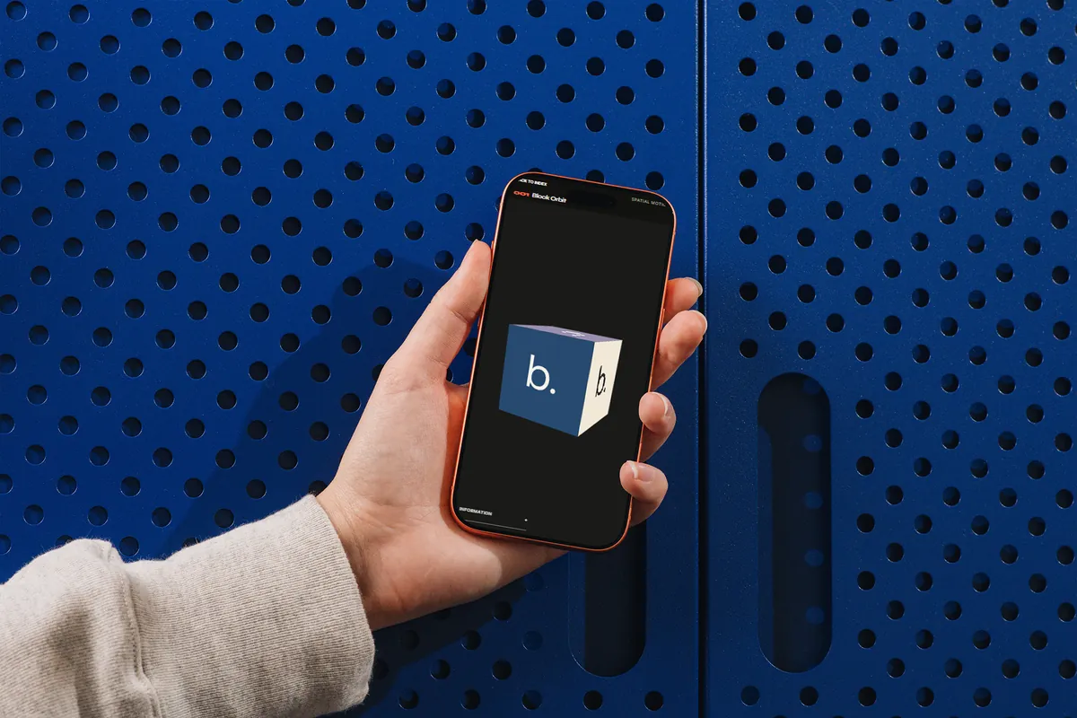 The Block Orbit page in dark mode on a phone, held against a blue perforated metal wall