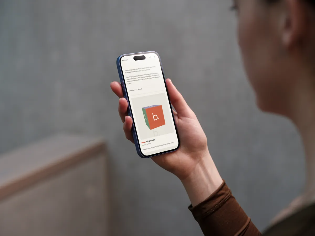 The Artifacts archive on a phone held in one hand
